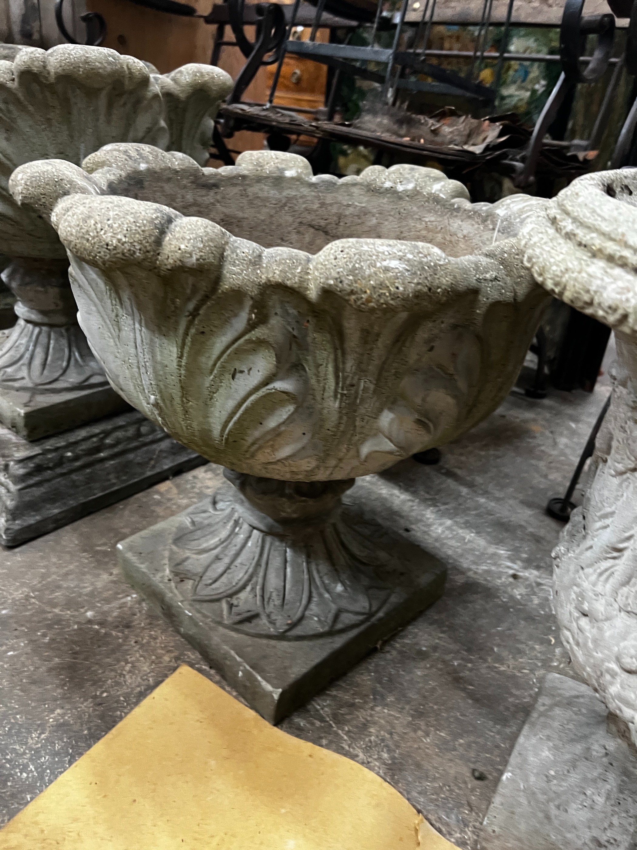Three circular reconstituted stone garden urns, the largest diameter 48cm, height 55cm